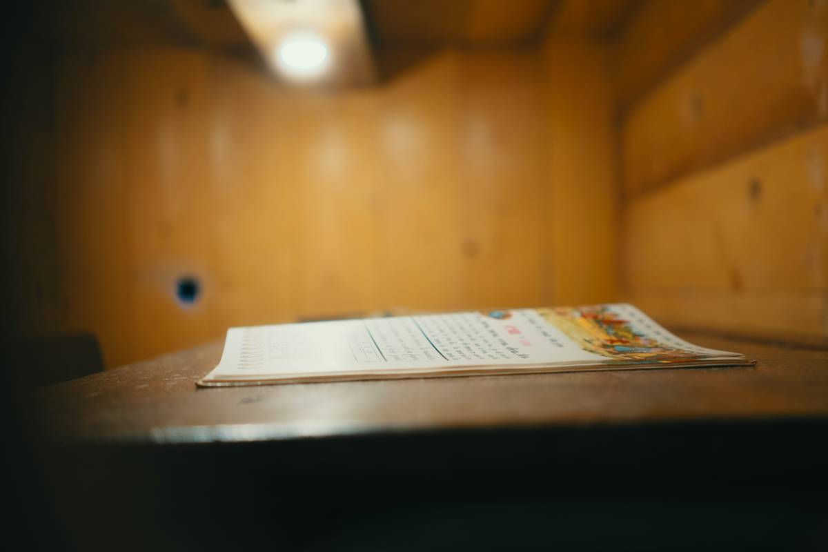 A person reviewing Cease-and-Desist Responses paperwork at a desk with legal documents and a laptop